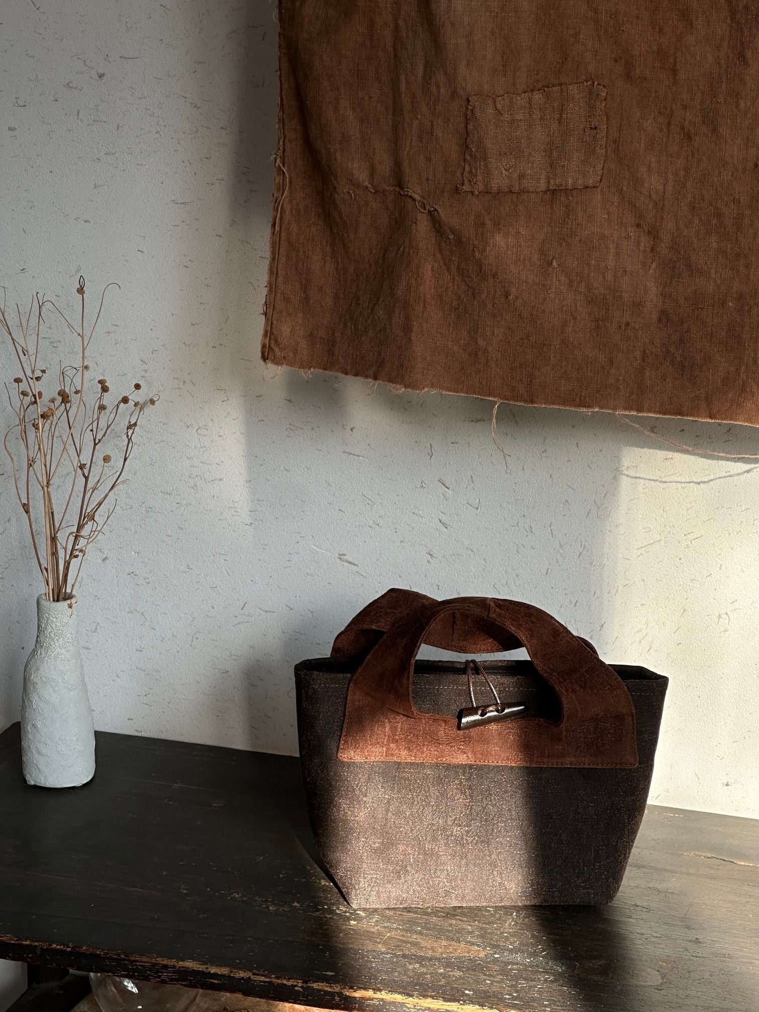 Artisan craftsmanship process of creating handmade silk handbags