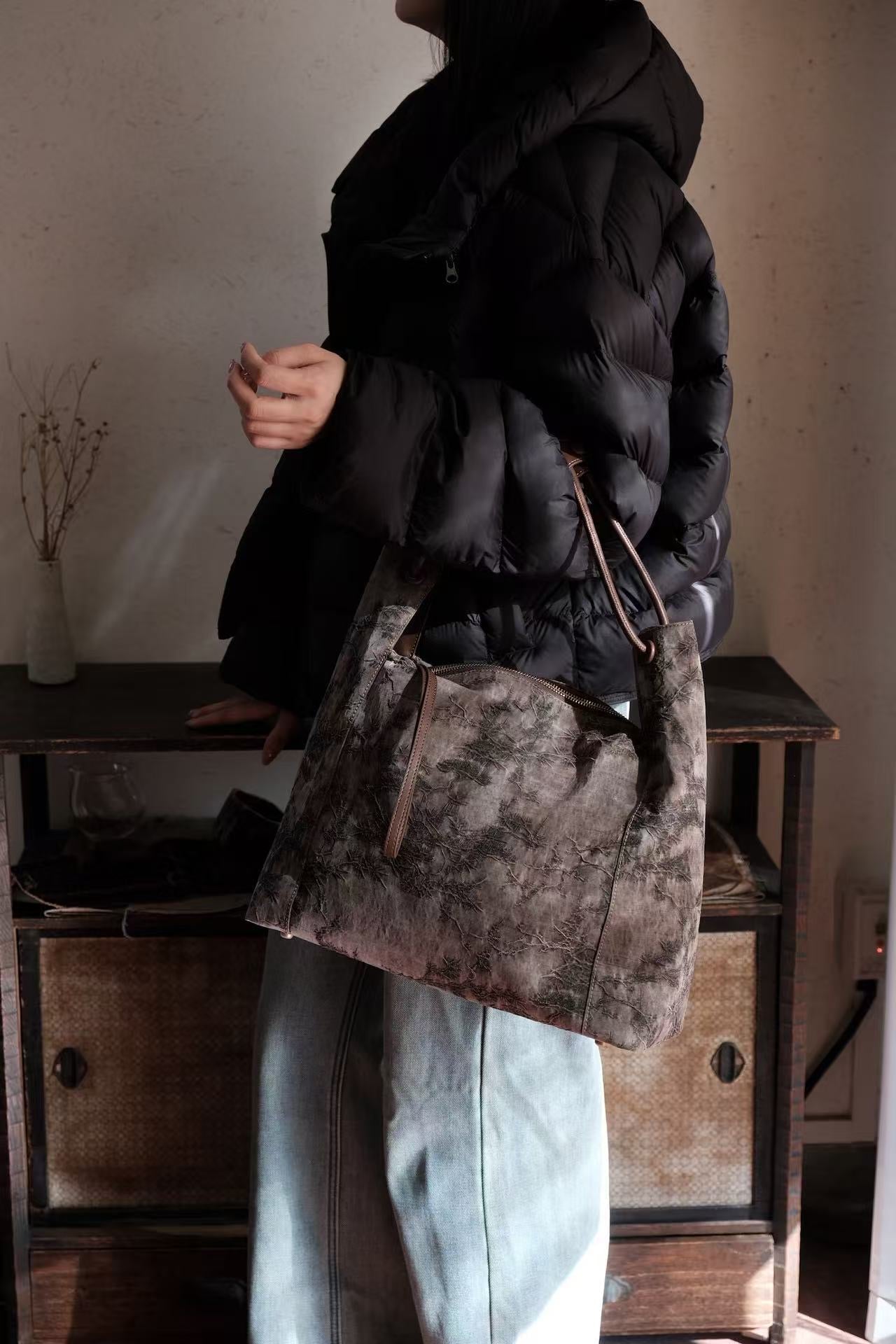 Elegant woman carrying luxury Xiangyunsha silk leather handbag