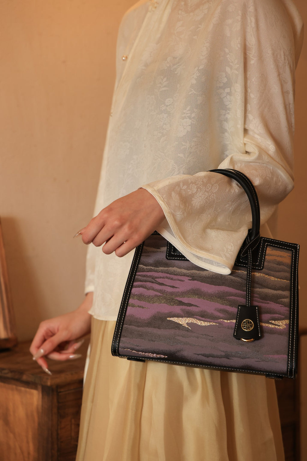 Artisan creating a handmade Nishijin silk handbag