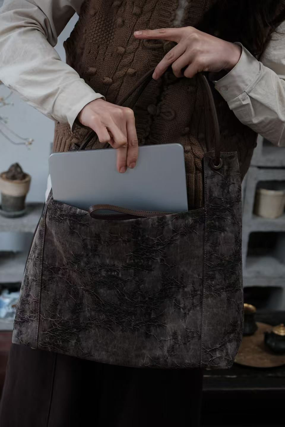 Interior view of handmade Xiangyunsha silk leather handbag with functional design