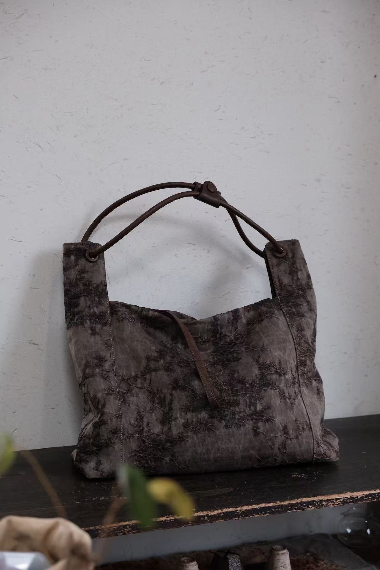 Back view of traditional Xiangyunsha silk leather handbag with premium craftsmanship