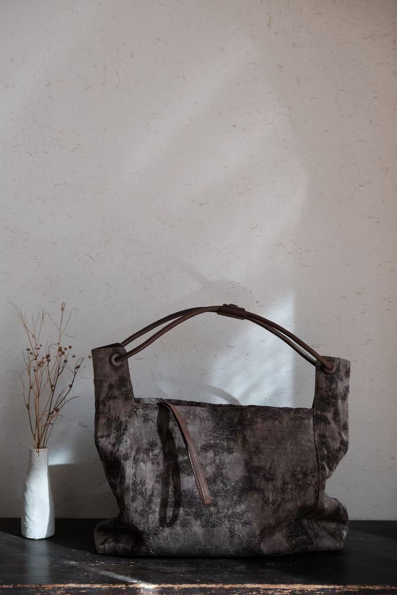 Collection of handmade Xiangyunsha silk leather handbags with heritage design