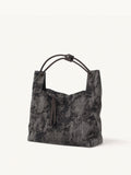 Handcrafted Xiangyunsha silk leather handbag inspired by Chinese heritage craftsmanship